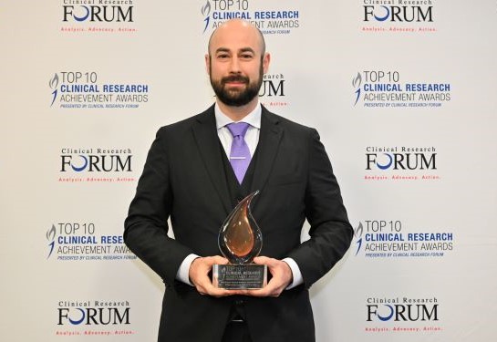 Neurosurgeon David Brandman holding CR Forum Award